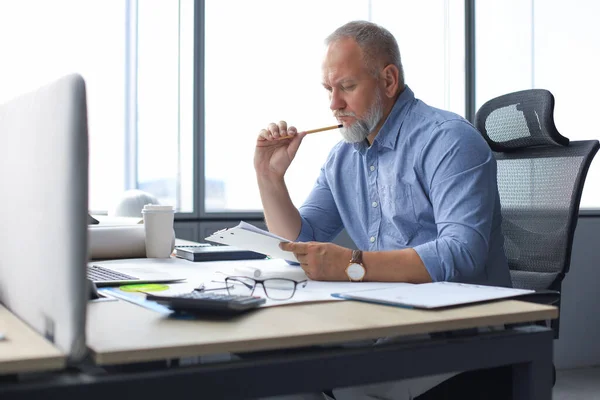 Good looking mature architect drawing something while working in the office. — Stock Photo, Image