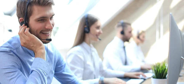 Ekibiyle birlikte çağrı merkezi çalışanının portresi. İşte gülümseyen müşteri destek operatörü.