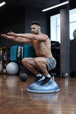 Spor salonunda jimnastik hemisfer bosu topu egzersiz yapan fit atlet
