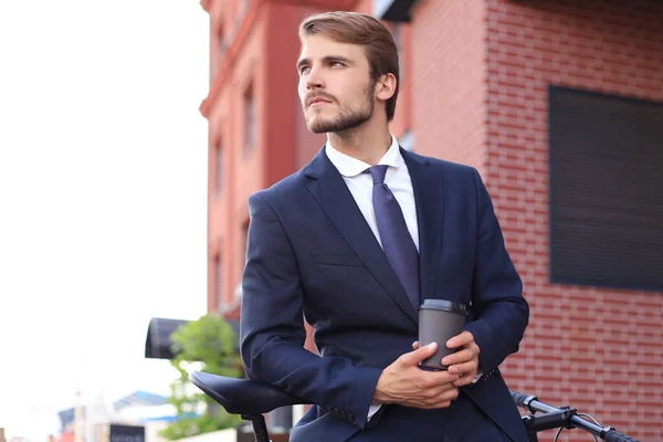 Pensive Young Businessman Holding Cup Coffee While Standing His Bicycle — Stock Photo, Image