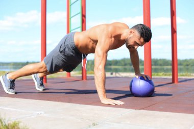 Güneşli bir günde spor salonunda spor yapan yakışıklı bir adamın görüntüsü..