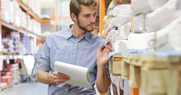 Young Man Shopping Working Hardware Warehouse Standing Checking Supplies His — Stock Photo, Image