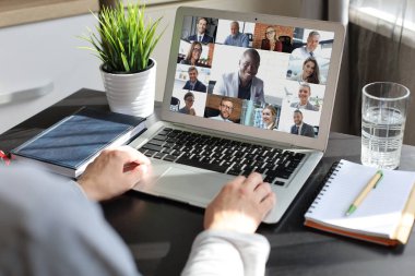 İş kadını video konferansında iş arkadaşlarıyla konuşuyor. Laptop kullanarak evden çalışan çok ırklı iş adamları.