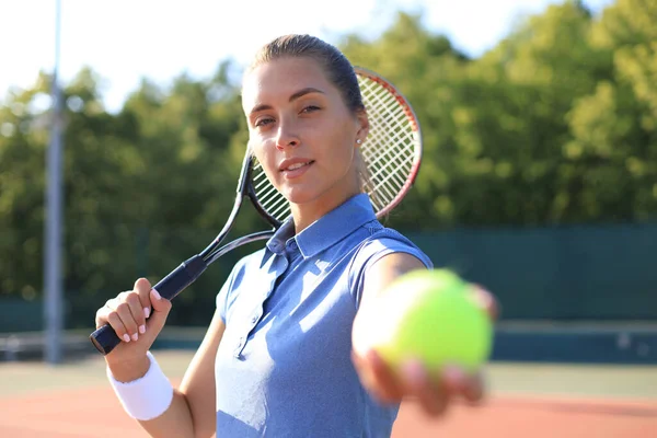 Beautiful tennis player serving the ball on the tennis court