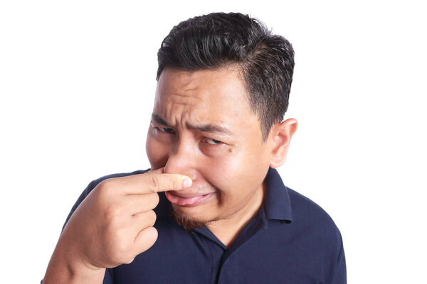 Asian Man Close His Nose Sick of Bad Smell