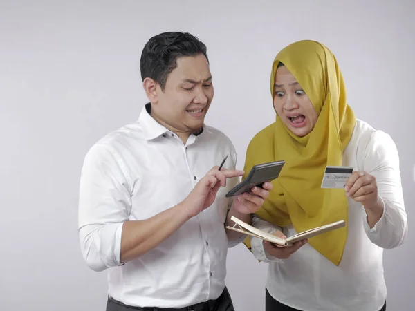 Muslim Couple Analyzing Financial Management Report