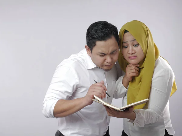 Muslim Couple Analyzing Financial Management Report