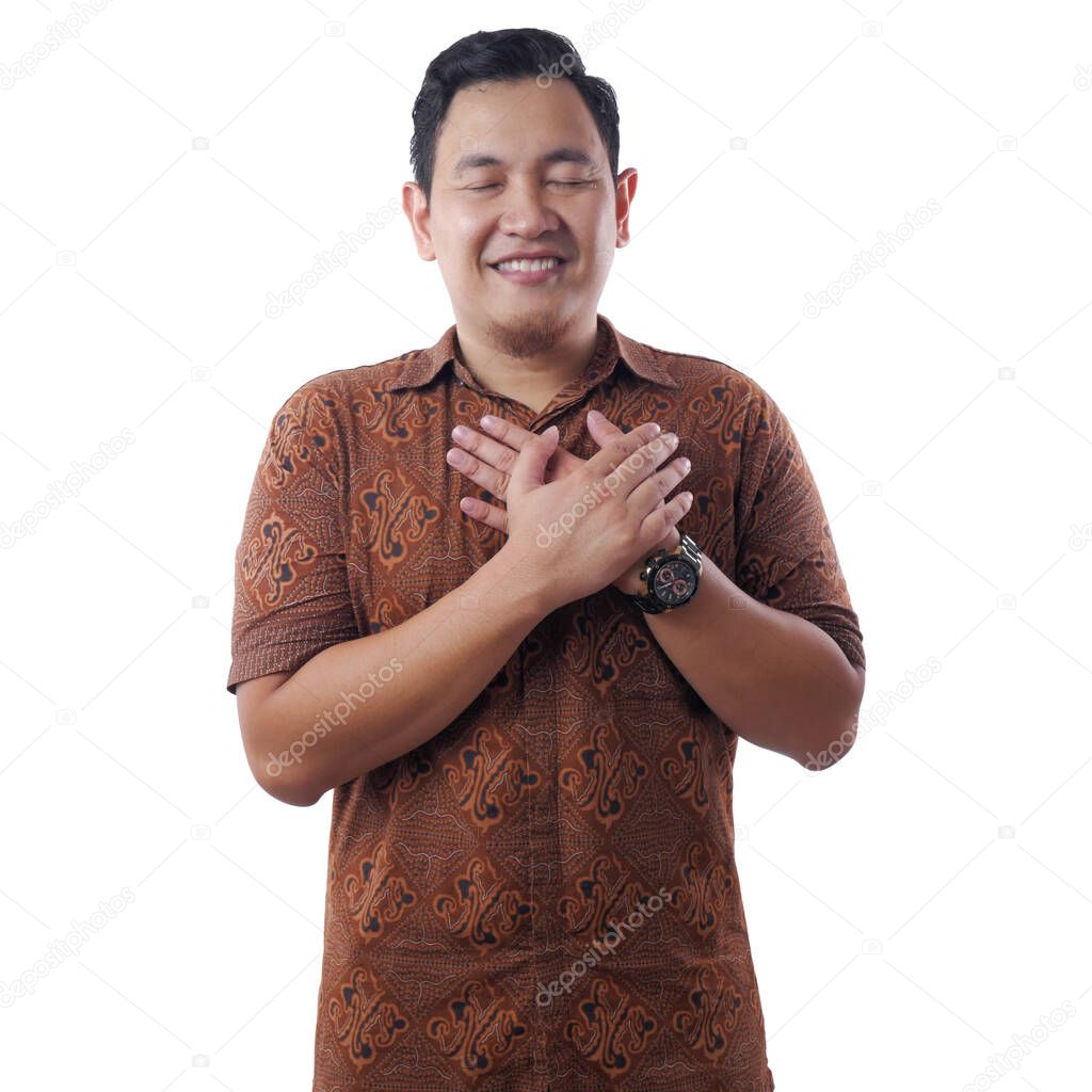 Asian man thankful gesture, hands on chest