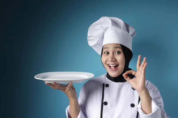 Asian Female Chef Shows Empty White Plate, Presenting Something, — Stock Photo, Image