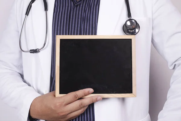 Doctor Holding Showing Empty Blackboard — Stock Photo, Image