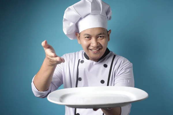 Asian Male Chef Shows Empty White Plate, Presenting Something, C — Stock Photo, Image