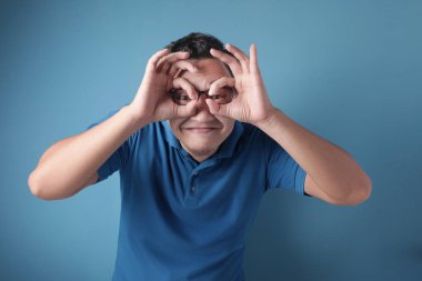 Teleskop yapan genç adam eliyle hareket ediyor.