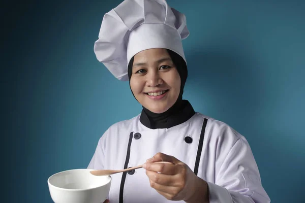 Aziatische vrouw chef-kok maken van soep, chef-kok proeven soep uit witte schaal — Stockfoto