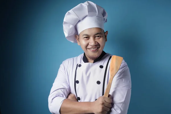 Aziatische man chef-kok klaar om te koken, chef-kok Holding keuken gereedschap spatel — Stockfoto