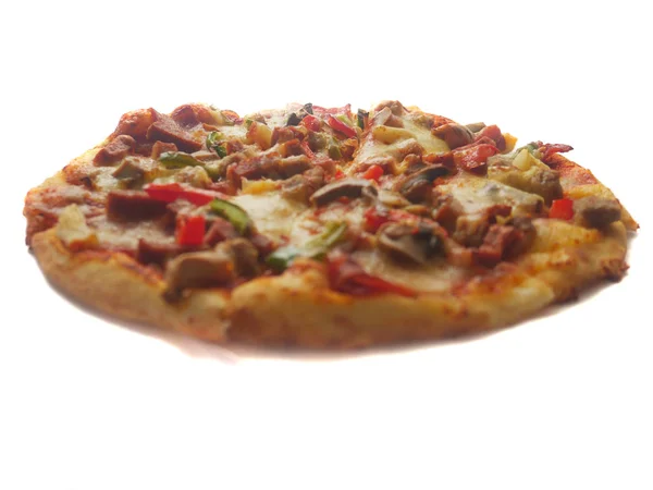 Pizza in round shape, topped with meat, ham, mushroom and veggies Stock Image