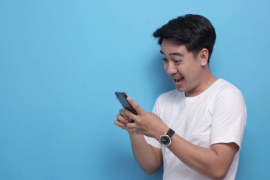 Mutlu gülümseyerek telefonundan sohbet mesaj okuma genç adam