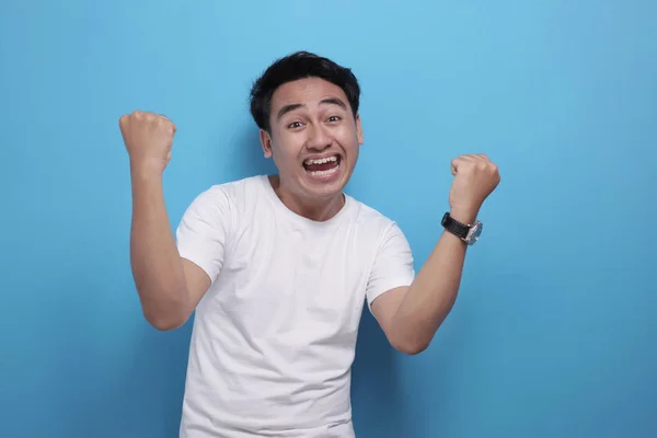 Happy Asian man shows winning gesture, celebrating victory — 스톡 사진