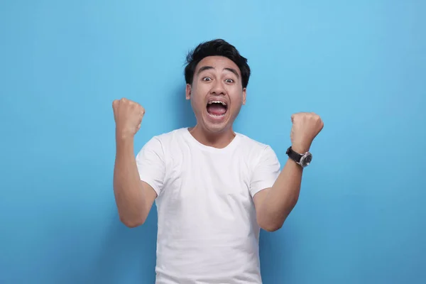 Happy Asian man shows winning gesture, celebrating victory — 스톡 사진