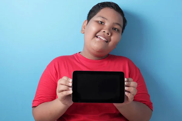 Gordo asiático chico muestra su tableta pantalla, tableta inteligente mock u — Foto de Stock