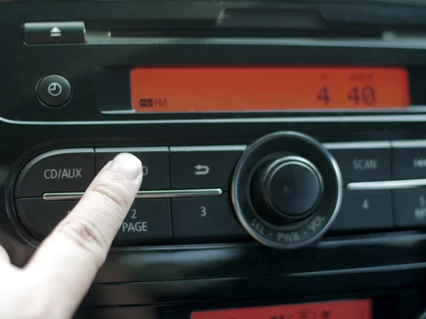 Driver\'s Hand Press Button on Car Radio