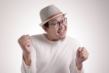 Gülümseyen ve ne mutlu ki, başarı jest kazanan iyi haber zaferini kutluyor ifade neşeli dans komik genç bir Asyalı adam portresi