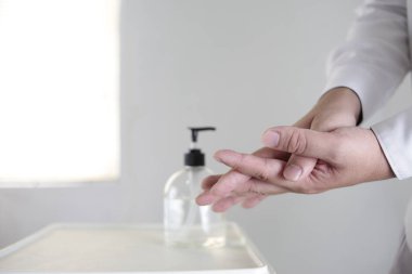 Alkol dezenfektanlarıyla el yıkamak ya da şişeden alkol jeli kullanmak. Covid-19 Corona virüs salgını enfeksiyon önleme ve kontrol. Hijyen ve sağlık hizmetleri kavramı 