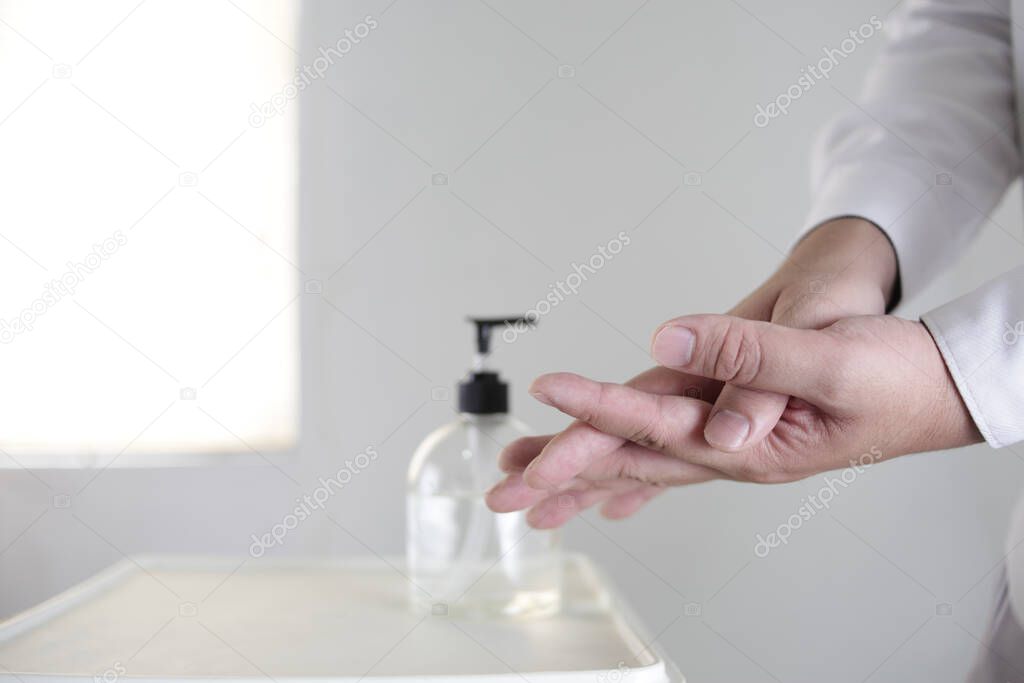 Washing hands by alcohol sanitizers or alcohol gel from pump bottle. Covid-19 corona virus outbreak infection prevention and control. Hygiene and health care concept 