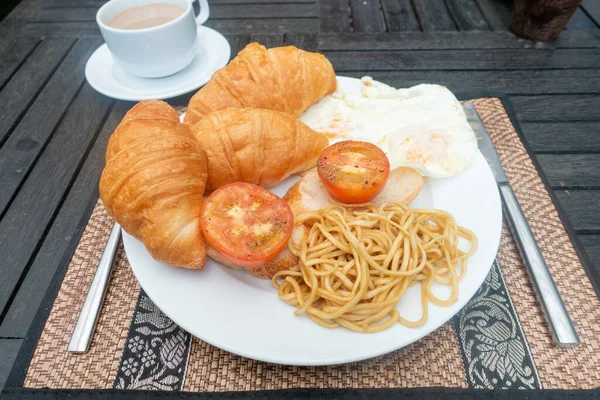 breakfast with coffee, eggs, tomato and pasta