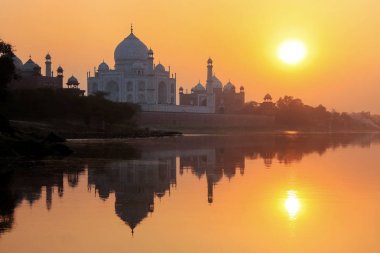 Taj Mahal reflected in Yamuna river at sunset in Agra, India clipart