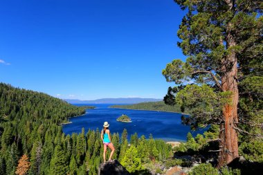 Young woman enjoying the view of Emerald Bay at Lake Tahoe, Cali clipart