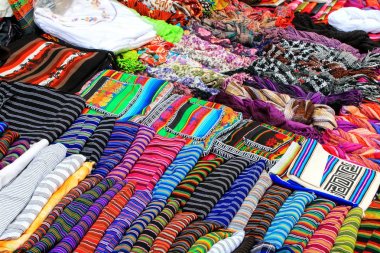 Display of traditional textile at the street market in Montevide clipart