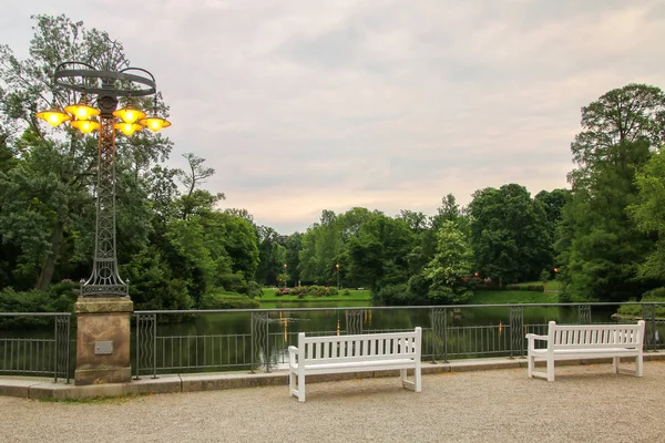 White benches by the lake in Kurpark, Wiesbaden, Hesse, Germany — Stock Photo, Image