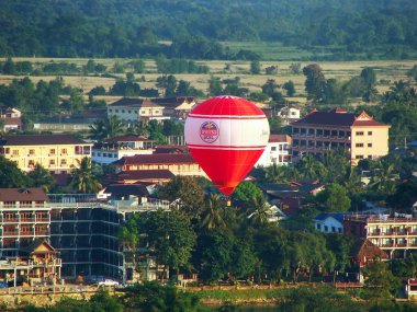 VANG VIENG, LAOS-NOVEMBER 26: Hot air balloon flying above Vang  clipart
