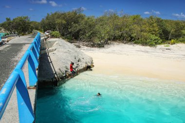 OUVEA, NEW CALEDONIA-JANUARY 8: Unidentified people jump off the Mouli Bridge between Ouvea and Mouli islands on January 8, 2018 at Loyalty Islands, New Caledonia. The population of Ouvea Island is about 3400 people.