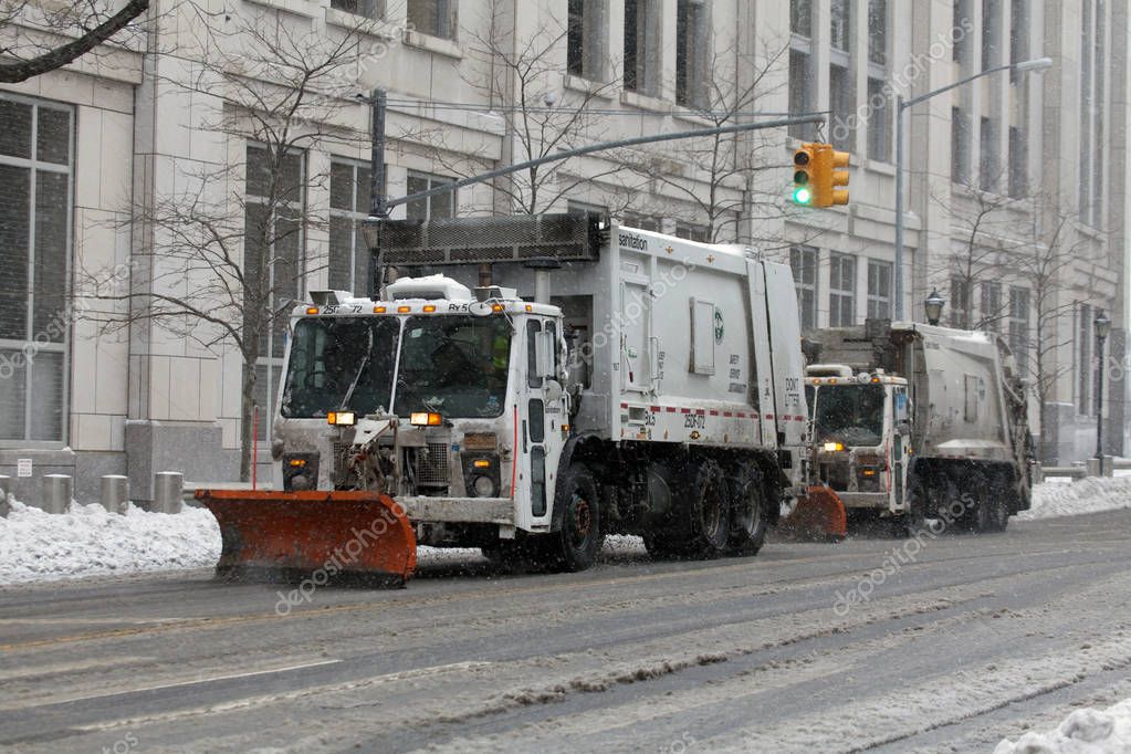 NYC Sanitation trucks plowing snow in the Bronx Stock Editorial Photo