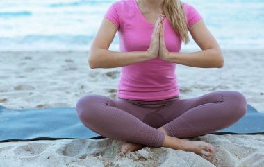  Kafkas Genç Kadın Sahilde Yoga Yapıyor, Okyanusta Arka planda. Spor Giyim 'deki kadın dışarıda dinleniyor. Sağlık İnsanları Konsepti. Görüntüyü kapat.