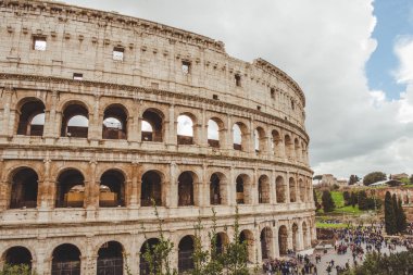 ROME, ITALY - 10 MARCH 2018: ancient Colosseum ruins with crowded square clipart