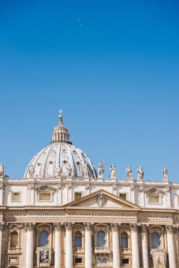 dome of St. Peter's Basilica under blue sky, Vatican, Italy clipart