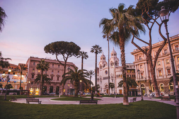 ROME, ITALY - 10 MARCH 2018: palm trees in square at Rome in evening