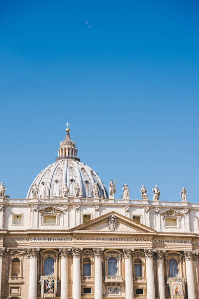 dome of St. Peter's Basilica under blue sky, Vatican, Italy