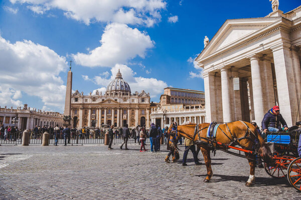 VATICAN, ITALY - 10 MARCH 2018: tourists walking by St. Peter's square