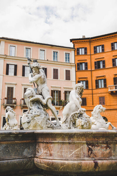 ancient statues on Fountain of Neptune in Rome, Italy