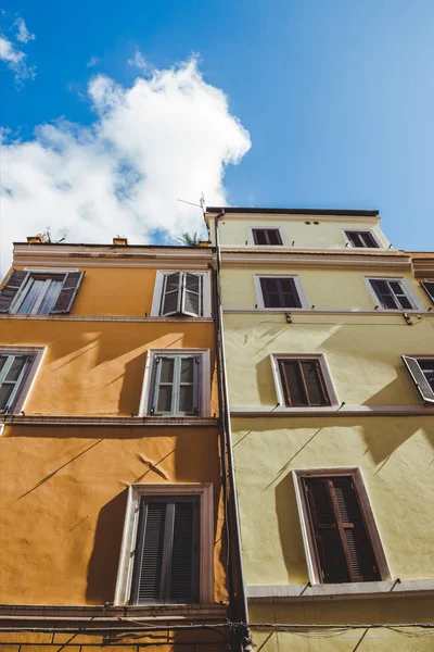 Bottom view of ancient buildings on street of Rome on sunny day, Italy — Stock Photo