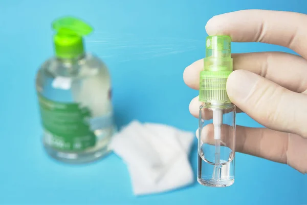 antiseptic sanitizer in a bottle with a spray in hand in rubber gloves