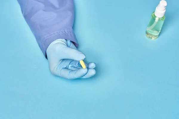 Doctor Holds One Yellow Pill His Hand Blue Background — Stock Photo, Image