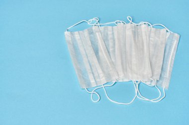 Mavi arka planda beyaz tıbbi maskeler