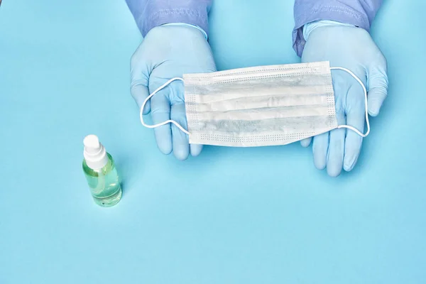 Doctor Gloves Holds Medical Mask His Hands Blue Background — Stock Photo, Image