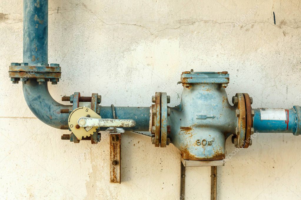 Closeup pipes and faucet valves of gas heating system in a boiler room