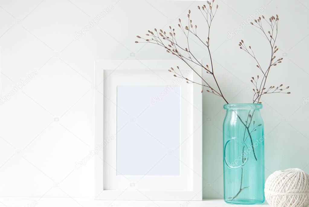 Minimal white frame with turquoise vase