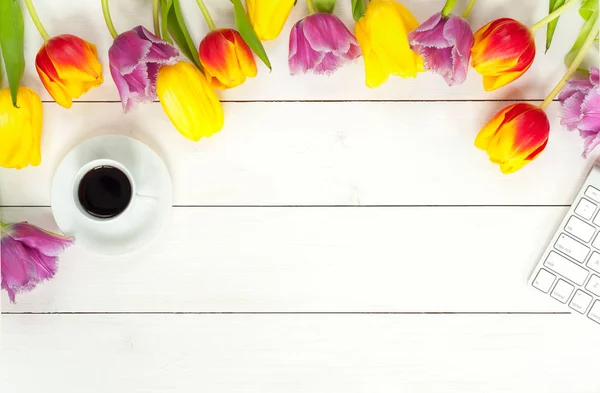 Tulpen, Kaffee und Tastatur auf weißem Holz — Stockfoto